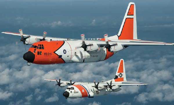 Hercules search and rescue aircraft flying above the clouds