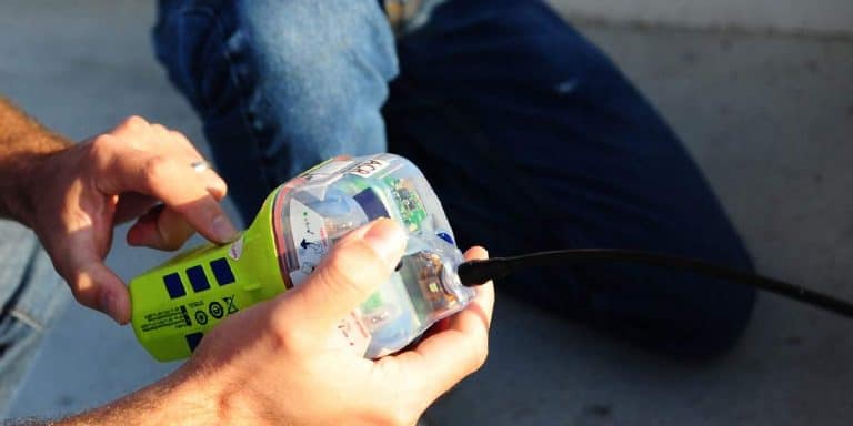 Close up of a sailor inspecting an EPIRB