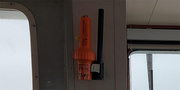 Orange SART mounted on the bulkhead of a ship