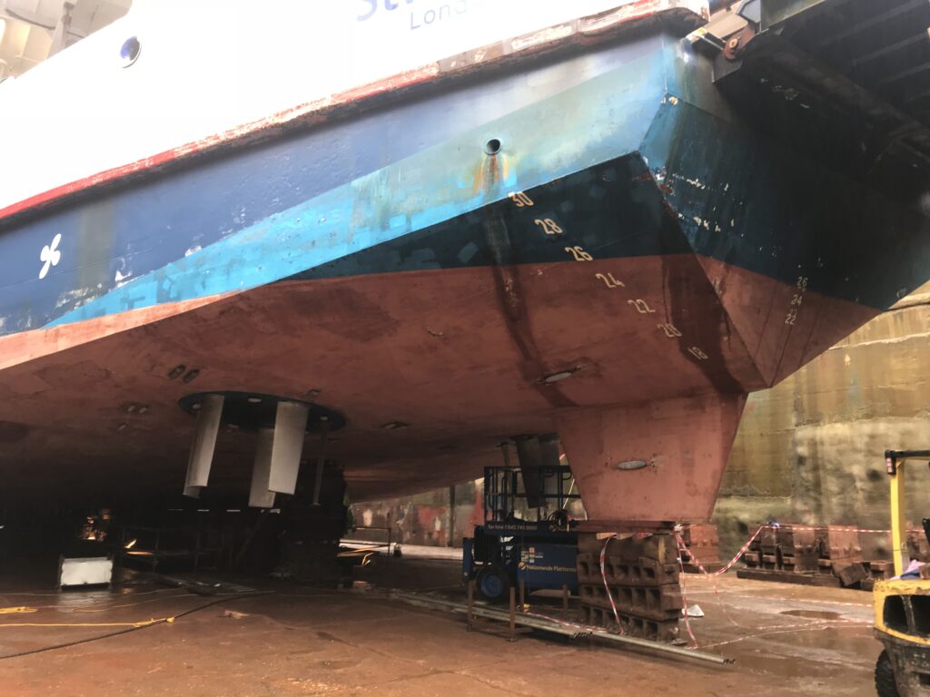 A photo showing the ferry St Clare in dry dock with her Voith Schneider propulsion units exposed