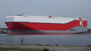 A photograph of the car carrier Olympian Highway, with a grey, red, and white hull