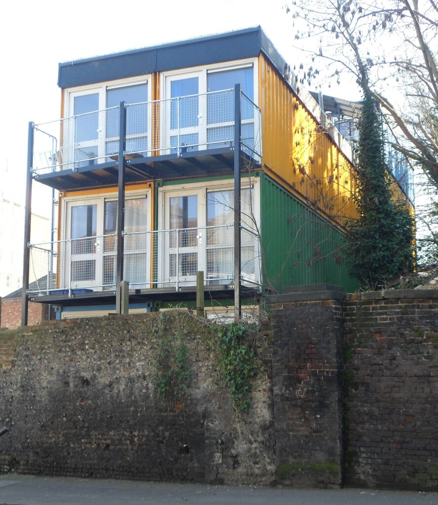 A photo showing a house constructed from old shipping containers